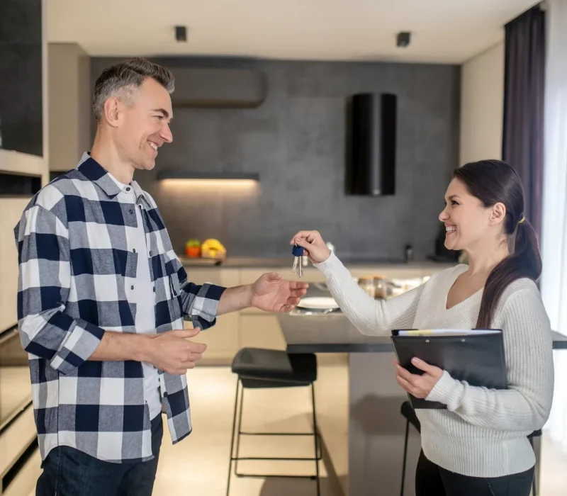 happy-man-taking-keys-from-realtor